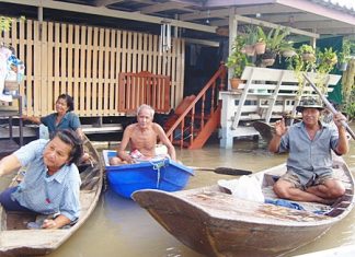 With their homes inundated, people need to use boats instead of cars.